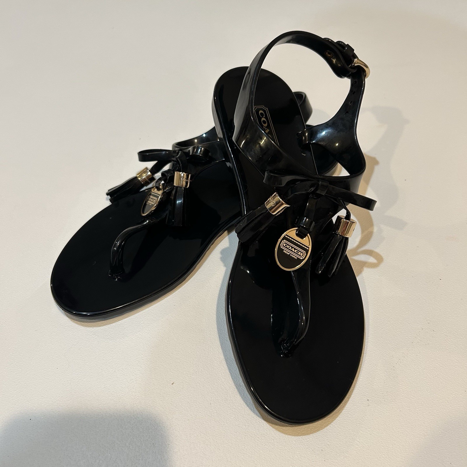 Coach Womans Size 6 Helma Jelly Thong Sandals Black Patent Leather Buckle Tassel