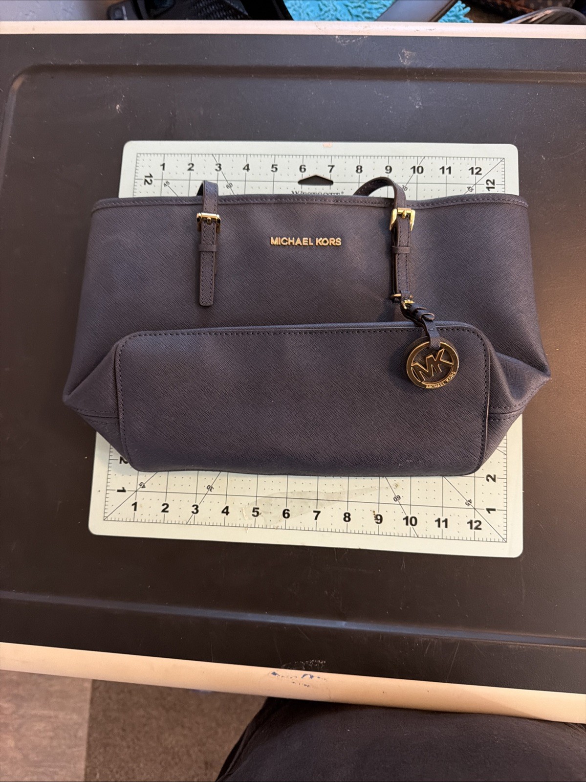Michael Kors tote features gold-toned hardware distinctive front buckle strap